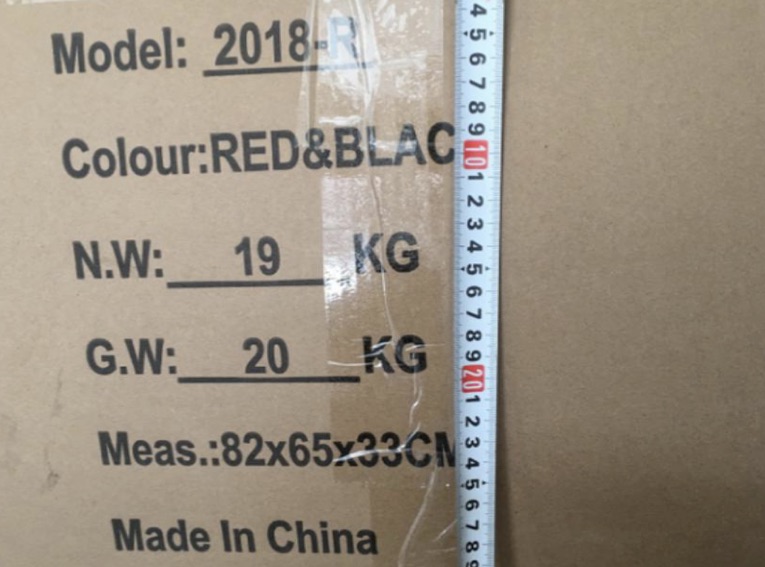 Carton label with model, color, weights and measurements beside a tape measure