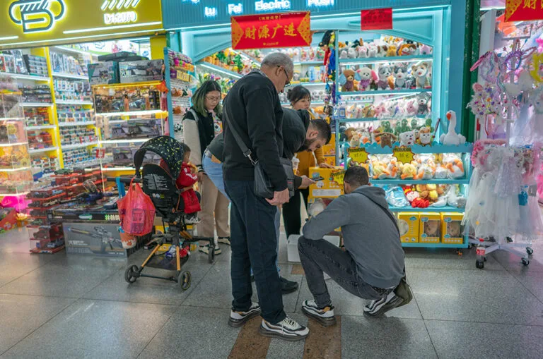 Buyers examining products at a toy booth in Yiwu Market