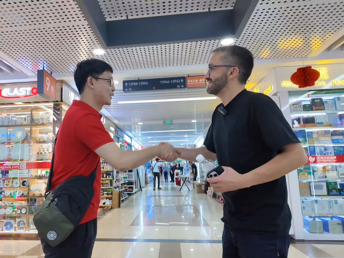 Lance team member shaking hands with a client in Yiwu Market